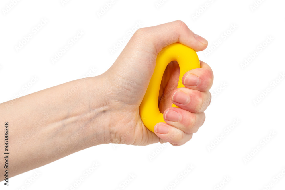 Yellow and orange expander in woman hand isolated on white background. Yellow and orange expander in woman hand isolated on white background.