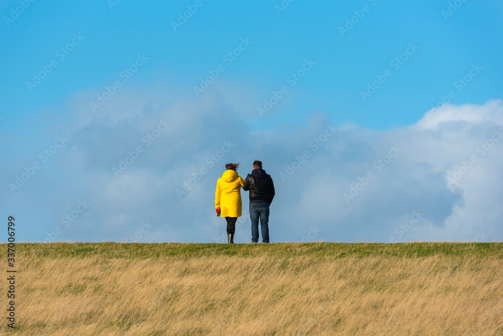 Tourists on the flood embankment by Westerhever