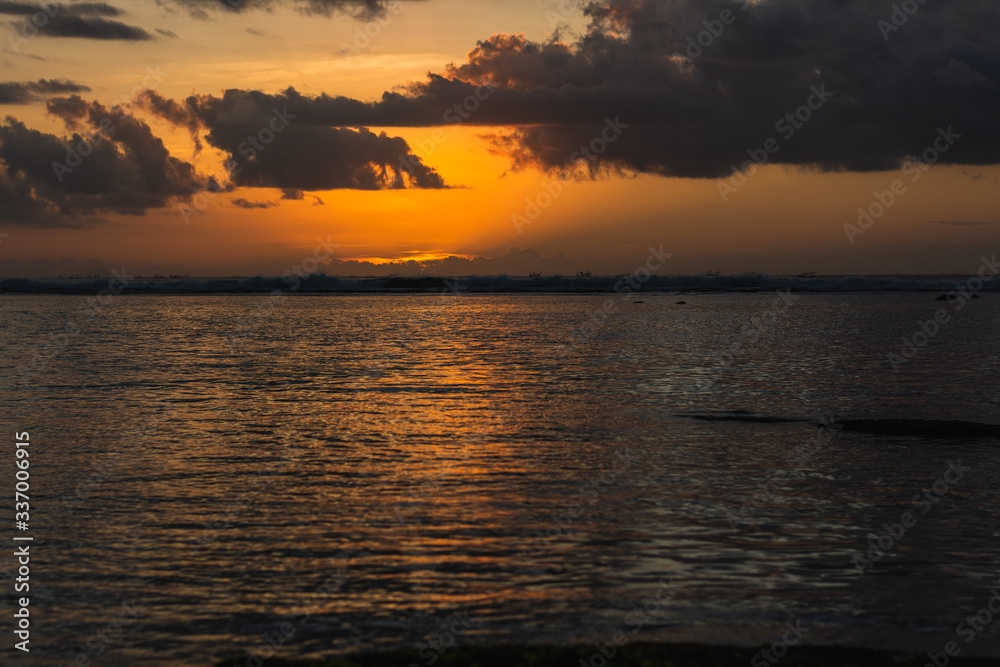 awesome sunset in bali indonsesia with clouds on the sea at horizon awesome sunset in bali indonsesia with clouds on the sea at horizon