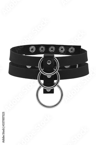 Subject shot of a black choker made as a collar of leather strips with steel studs and chrome-plated rings. The stylish accessory is isolated on the white background.  photo