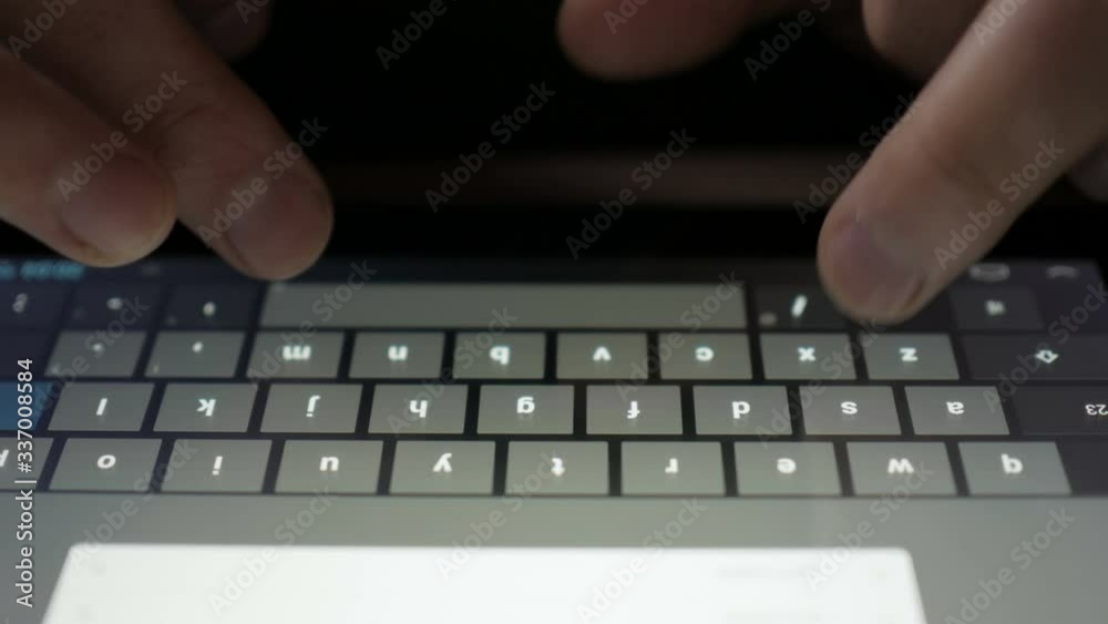 Typing on a virtual keyboard of tablet pc. Finger touching virtual keys form a digital keyboard of a touchscreen tablet-PC. A person writes a text message. Texting. Typing on a virtual keyboard of tablet pc. Finger touching virtual keys form a digital keyboard of a touchscreen tablet-PC. A person writes a text message. Texting.
