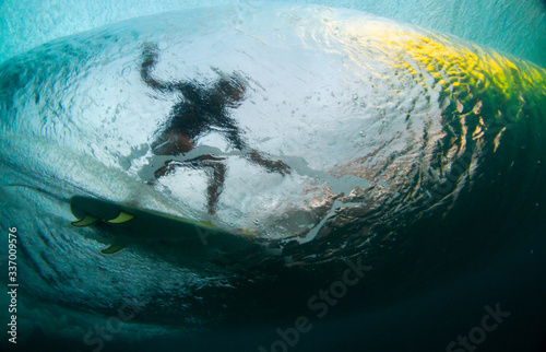 Fototapeta Naklejka Na Ścianę i Meble -  underwater shot silhouette of a surfer riding a wave