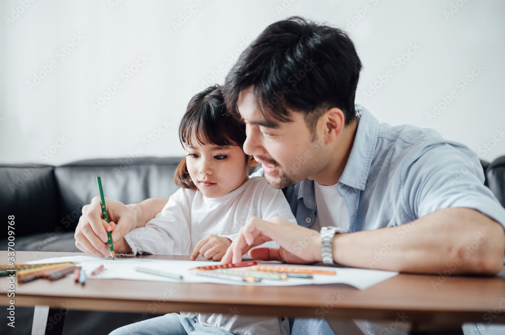 Father and daughter at home painting Father and daughter at home painting