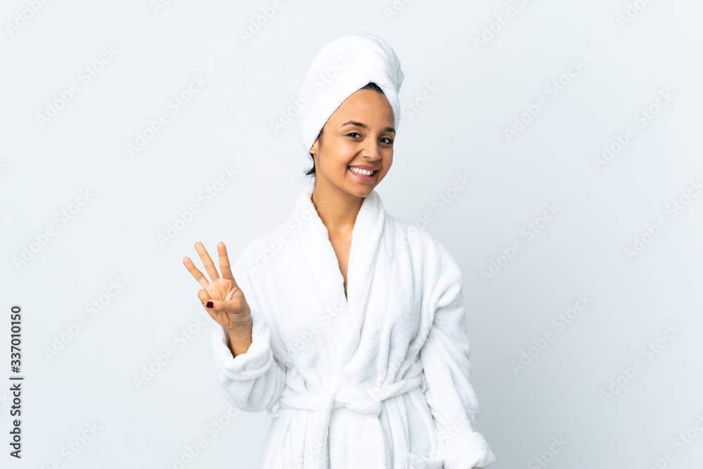 Young woman in bathrobe over isolated white background happy and counting three with fingers Young woman in bathrobe over isolated white background happy and counting three with fingers