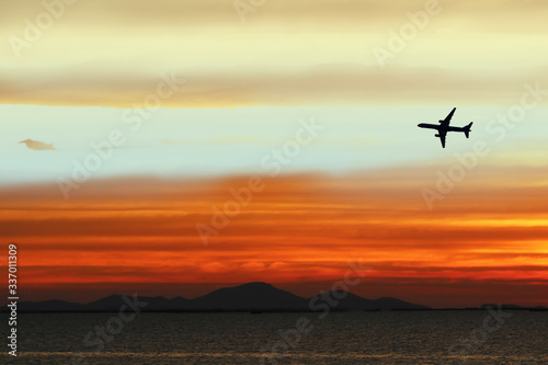 silhouette airplane on sky in sunset back on cloud white orange yellow red color © darkfoxelixir