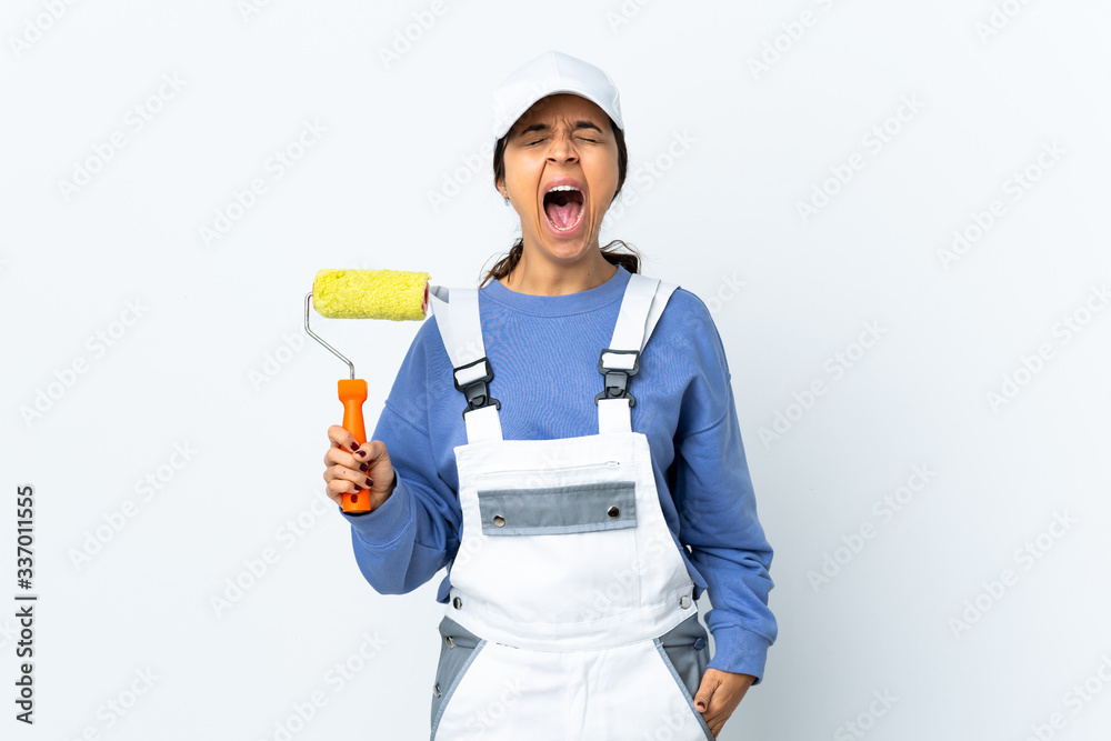 Painter woman over isolated white background shouting to the front with mouth wide open Painter woman over isolated white background shouting to the front with mouth wide open