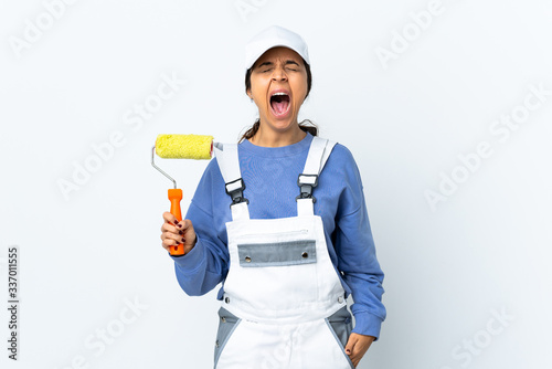 Painter woman over isolated white background shouting to the front with mouth wide open