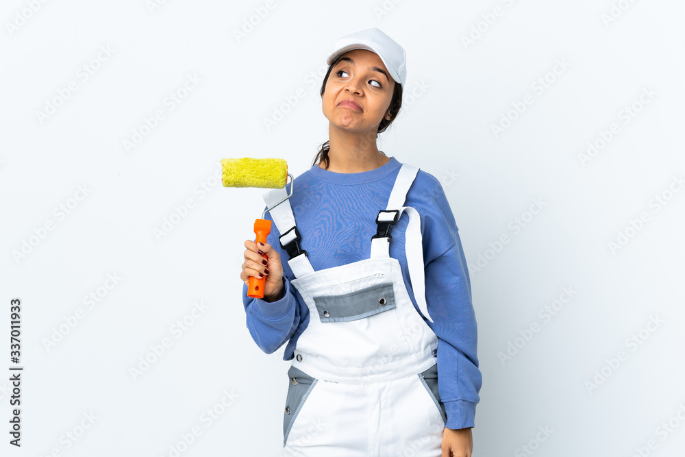 Painter woman over isolated white background having doubts while looking up Painter woman over isolated white background having doubts while looking up