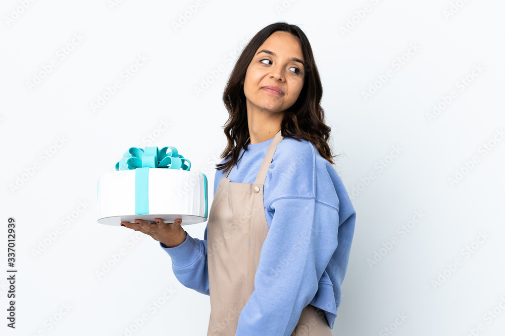 Pastry chef holding a big cake over isolated white background . Portrait Pastry chef holding a big cake over isolated white background . Portrait
