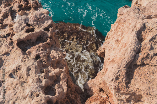 Texture of Volcanic rock surface in Cyprus. cliff, sea in the background. selective focus © CameraCraft