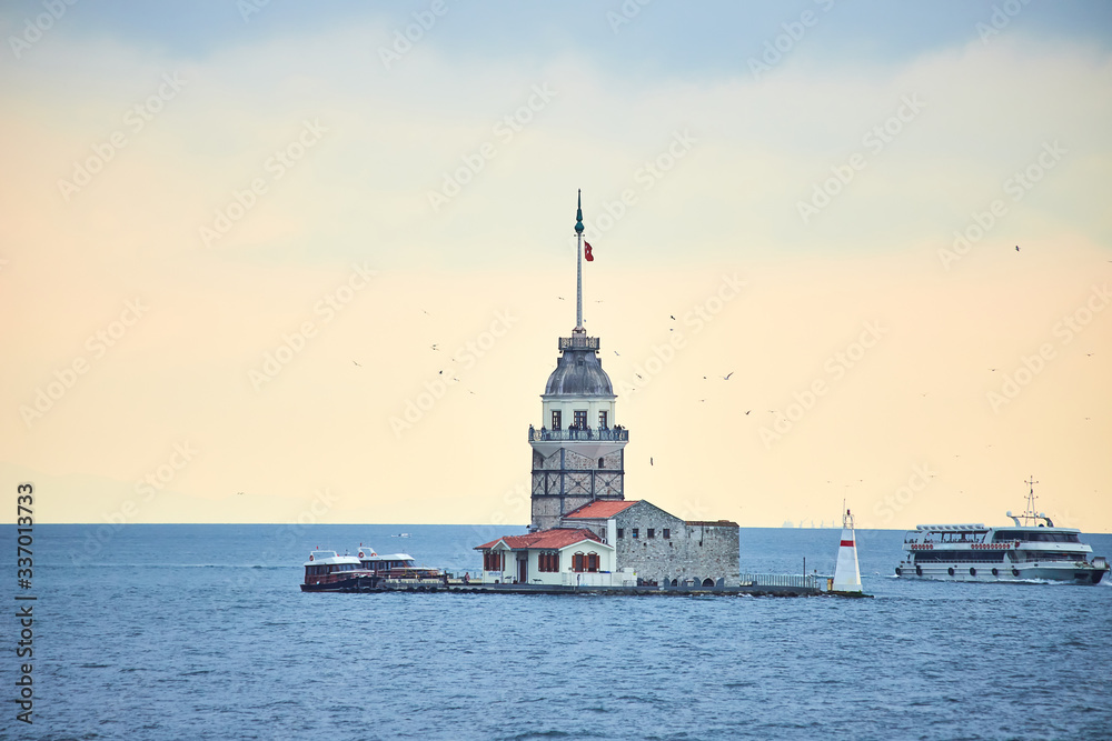 Fiery sunset over Bosphorus with famous Maiden's Tower (Kiz Kulesi in Turkish) also known as Leander's tower, symbol of Istanbul, Turkey Fiery sunset over Bosphorus with famous Maiden's Tower (Kiz Kulesi in Turkish) also known as Leander's tower, symbol of Istanbul, Turkey