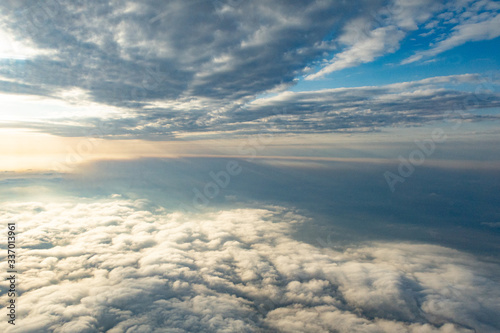 Clouds from above from an airplane on a sunny day.