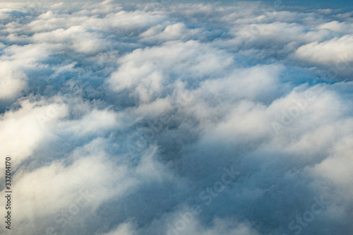 Fototapeta Naklejka Na Ścianę i Meble -  Clouds from above from an airplane on a sunny day.