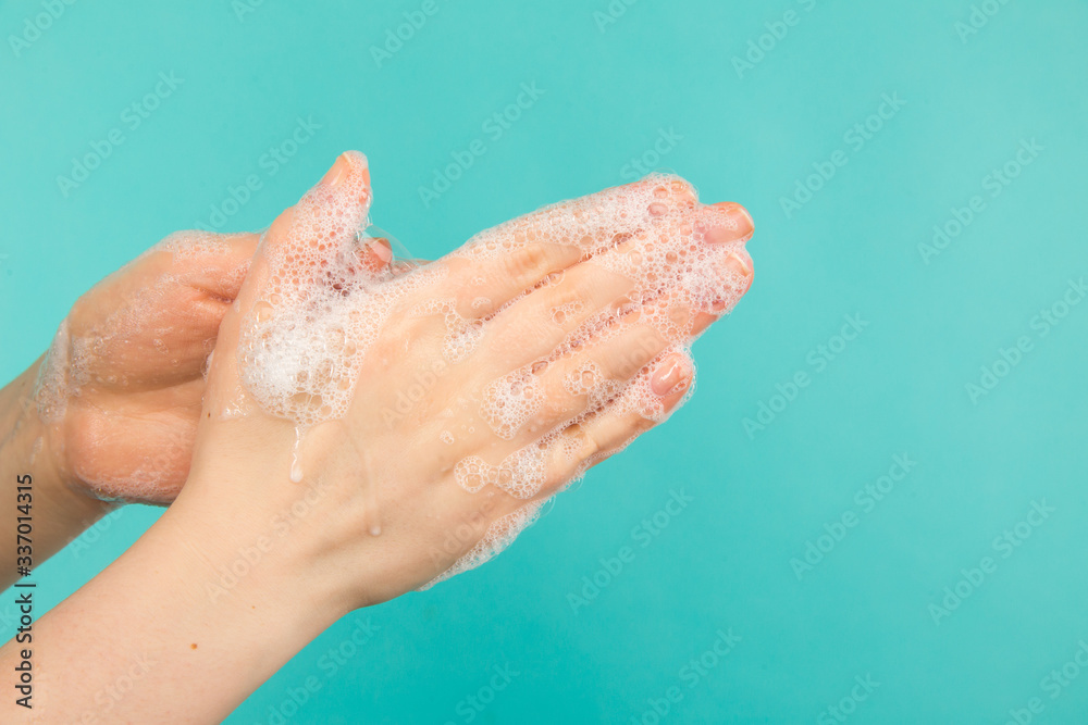 Hygiene concept. Closeup picture of woman's hands in a soap and sanitiser Hygiene concept. Closeup picture of woman's hands in a soap and sanitiser