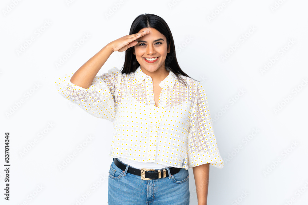 Young latin woman woman isolated on white background saluting with hand with happy expression Young latin woman woman isolated on white background saluting with hand with happy expression
