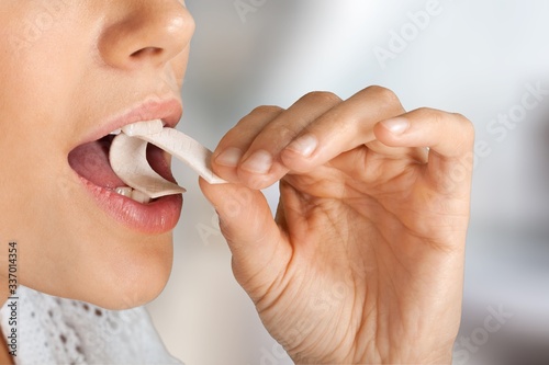 Young beautiful girl while enjoying sweet gum