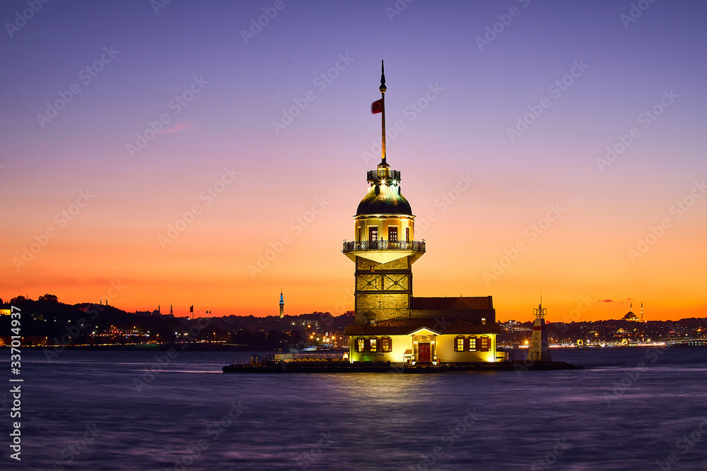 Fiery sunset over Bosphorus with famous Maiden's Tower (Kiz Kulesi in Turkish) also known as Leander's tower, symbol of Istanbul, Turkey