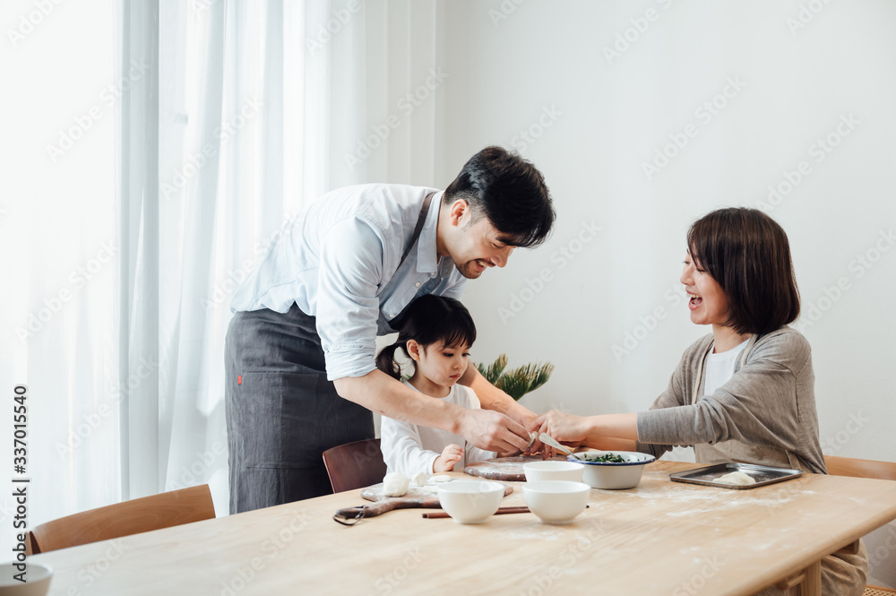Mom and Dad and daughter at home dumplings Mom and Dad and daughter at home dumplings