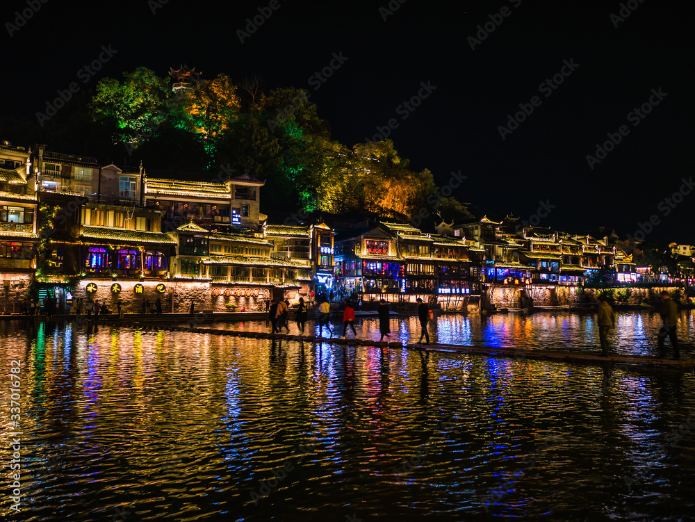 fenghuang,Hunan/China-16 October 2018:Tourist walking with beautiful Scenery view in the night of fenghuang old town .phoenix ancient town or Fenghuang County is a county of Hunan Province, China