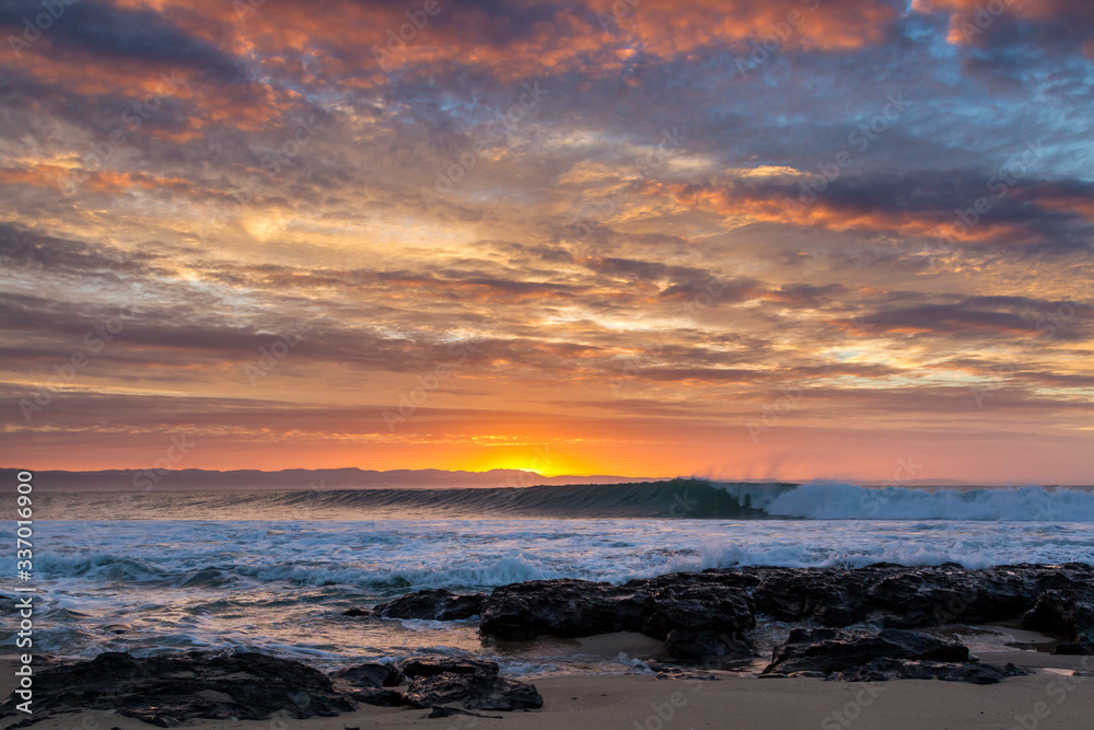 sunrise over waves rolling into super tubes at Jeffrey's bay