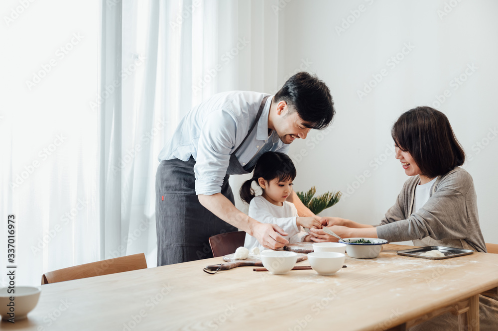 Mom and Dad and daughter at home dumplings Mom and Dad and daughter at home dumplings