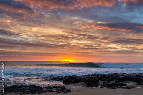 sunrise over waves rolling into super tubes at Jeffrey's bay © Sacha Specker