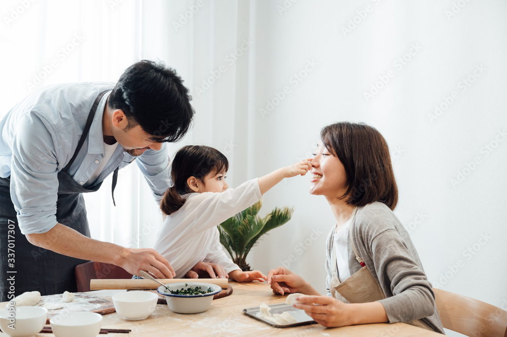 Mom and Dad and daughter at home dumplings Mom and Dad and daughter at home dumplings