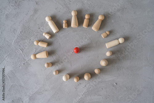 Slika na platnu Virus infected red wooden man communicate with people stand in a vicious circle on a gray background