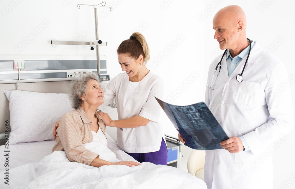 Obraz premium Medical Caring about senior people. elderly patient lying in a hospital bed, having nurse support. Clinic treatment and care for the elderly