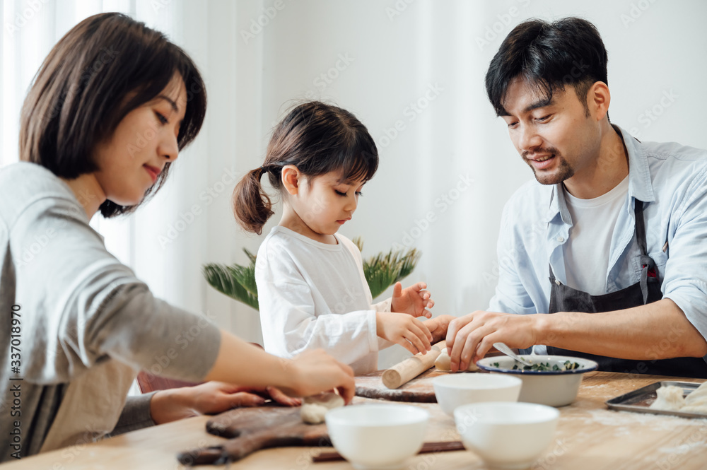 Mom and Dad and daughter at home dumplings Mom and Dad and daughter at home dumplings
