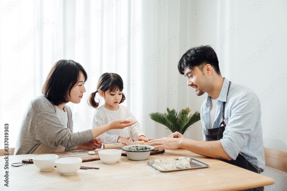 Mom and Dad and daughter at home dumplings