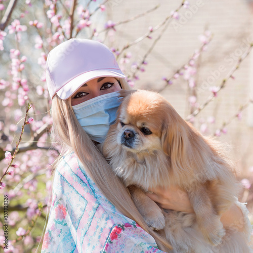 Young woman in protect mask with a dog, anti alergy, stop virus, save yourself 