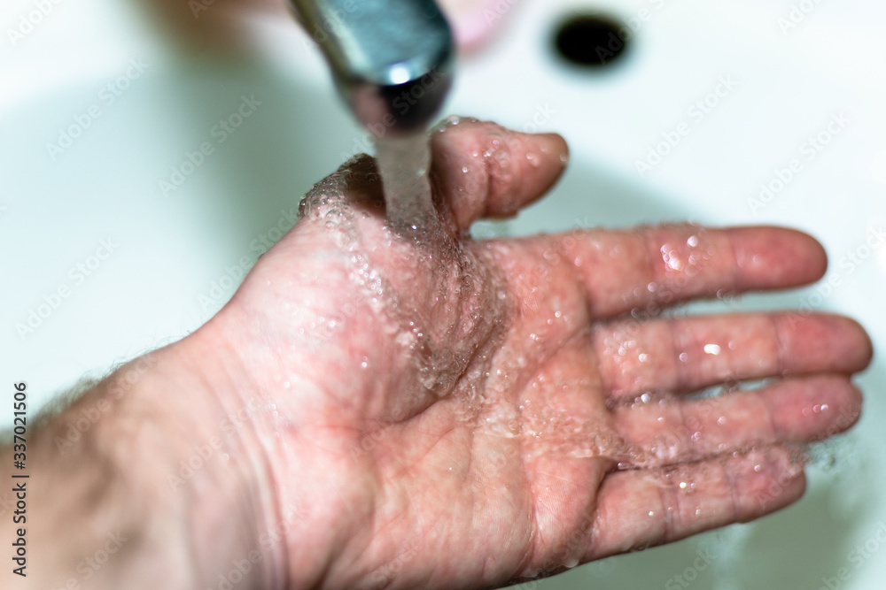 Fototapeta premium Male hand. Hand washing with water in the sink.