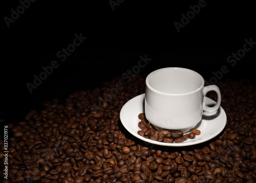 Cup with coffee beans on a dark background