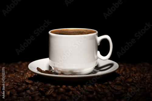 Cup with coffee beans on a dark background