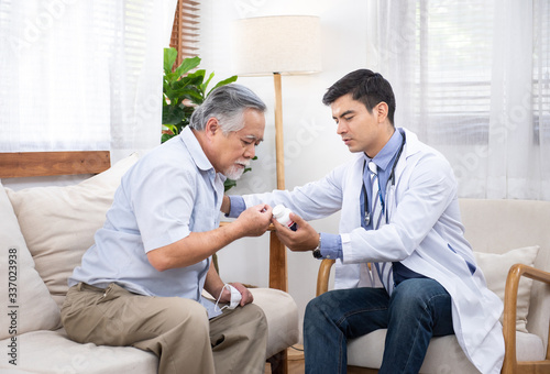 Senior elder asian man asking young caucasian doctor about indications and contraindications of new medicine, healthcare and medicine concept with copy space.