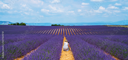 Nature fhotography concepts professional photographer. Traveler girl taking nature video of lavender field. Professional videographer on vacation shooting camera on tripod. photo