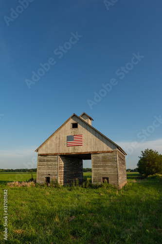 Old wooden barn with american flag.