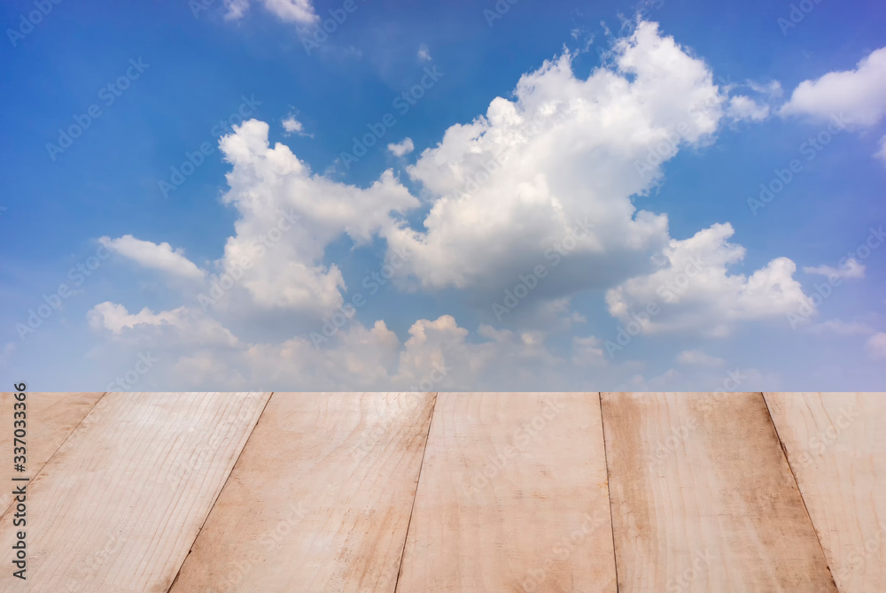 Wood table top with blue sky background