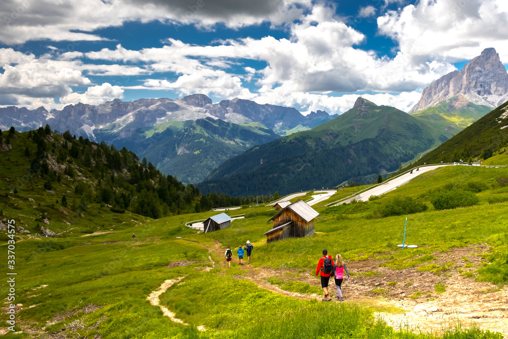 Backpackers hiking. Tourists on the trial in Italian Dolomites. South Tyrol. Italy. Europe.