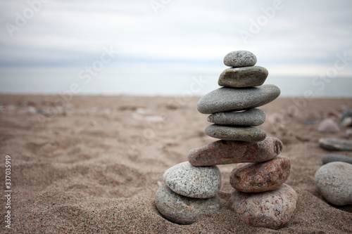 A stone inukshuk on a beach.
