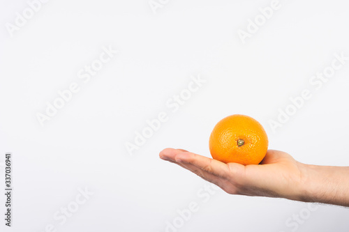 Close Up of Hand Man Holding an Orange Over white Background.