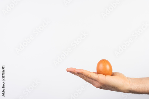 Man Hand Holding Egg Over White Background.