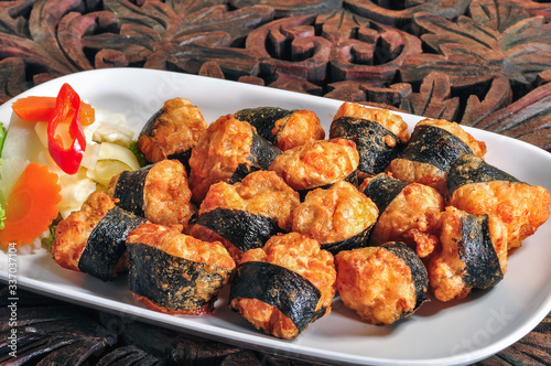 Crispy Seaweed Stuffed Shrimp in white plate on the wooden table. photo