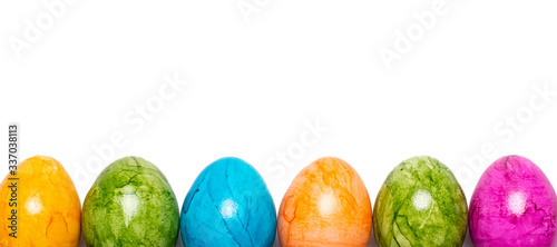 Border of easter eggs in different colors on white background