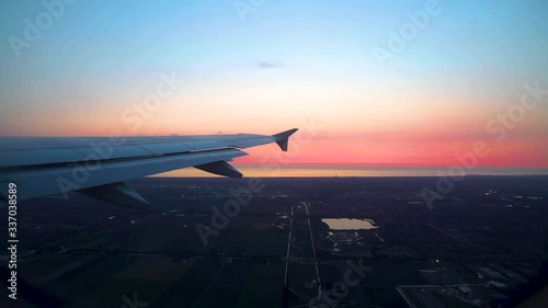 View of Airplane Wing From Window Landing in Italy During Sunset photo