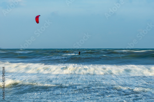 Kitesurfing on the waves of the Mediterranian in Mersin beach, Turkey.