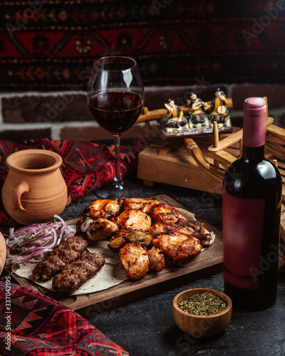 mixed kebab and bottle of red wine © Kamran