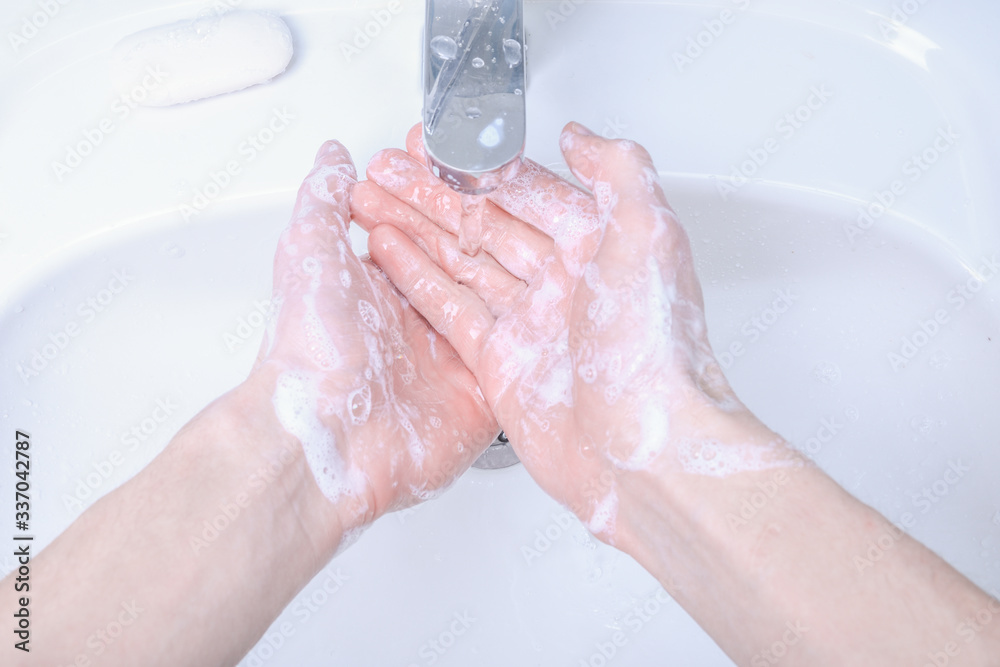 Fototapeta premium Washing hands in the sink rubbing with soap man for corona virus ,COVID-19 prevention, hygiene to stop spreading coronavirus.Destruction of the virus