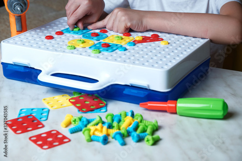 child collects a constructor puzzle